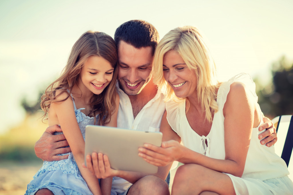 happy family using a tablet outdoors