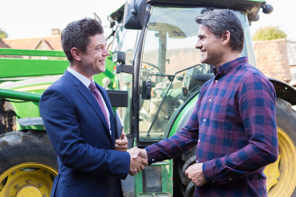 businessman partnering with a farmer