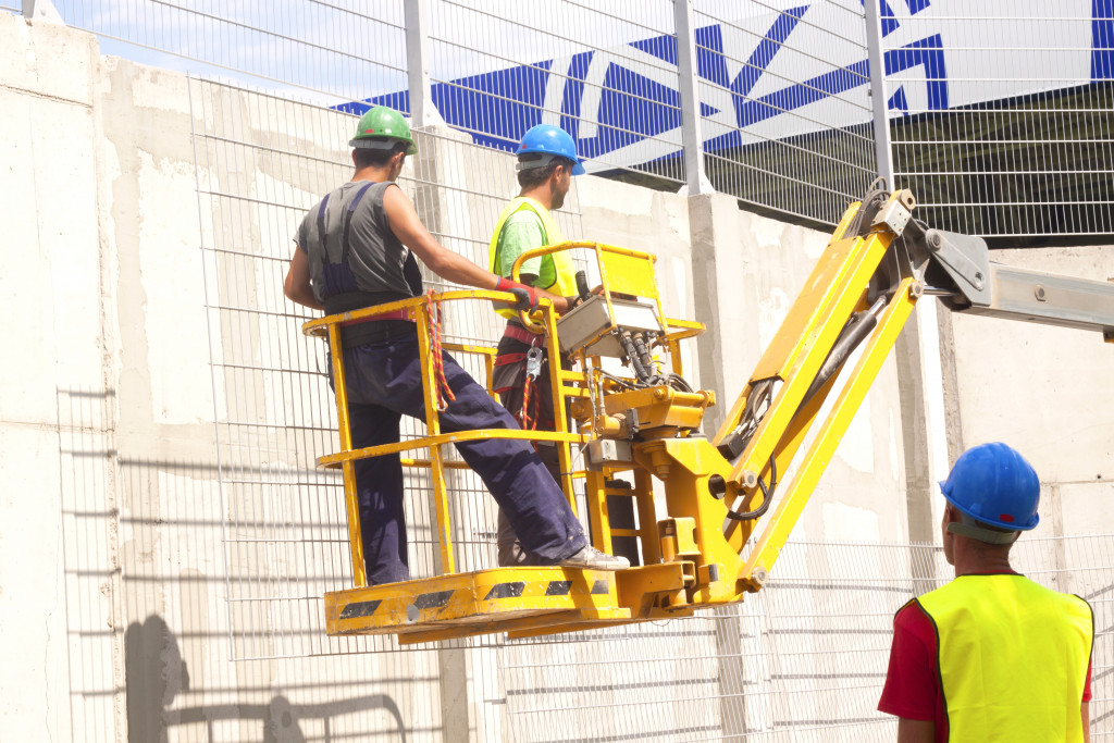 An image of construction workers on a mobile platform